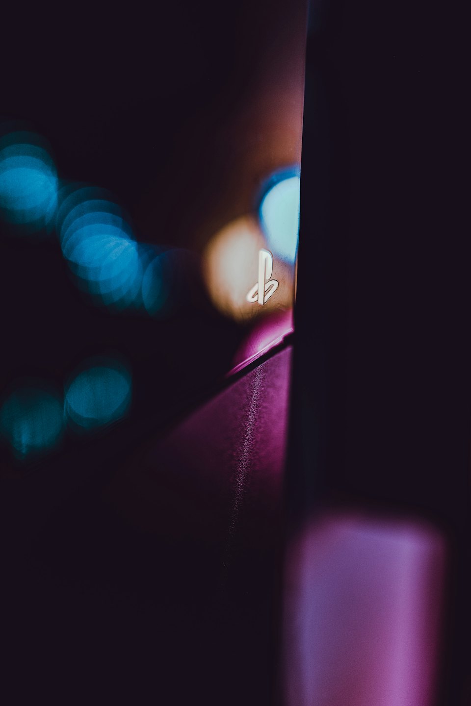 PlayStation logo glowing on a dark game console.